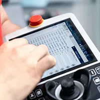 Paint shop worker adjusting robot trajectory