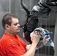 Paint shop worker setting up robotic trajectory