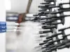 Metal parts being coated with powder coating