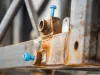 Corroded part with blue screw covers
