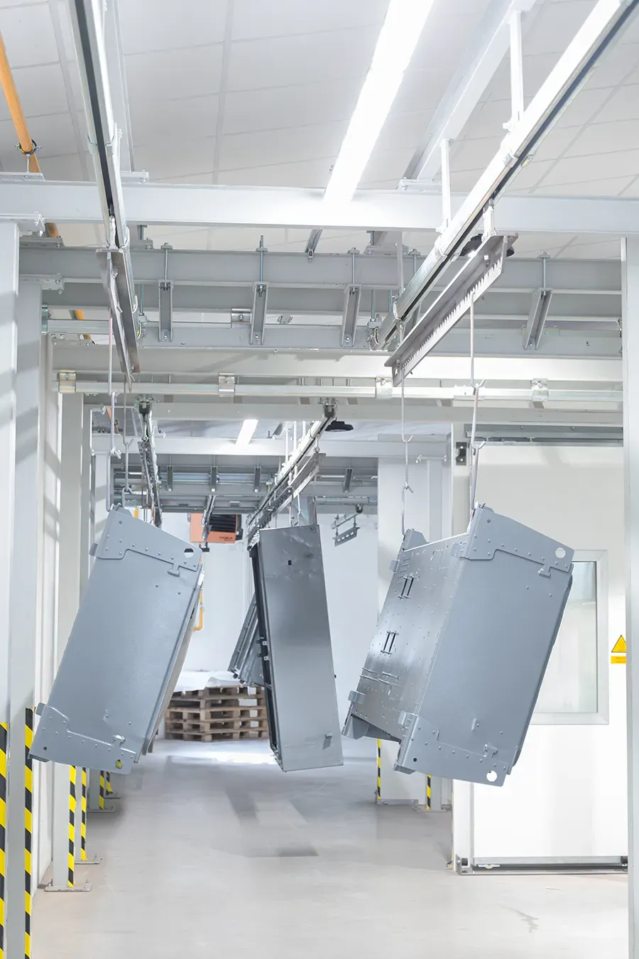 Parts finished coating on overhead conveyor