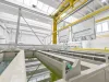 Metal part above vats with liquid