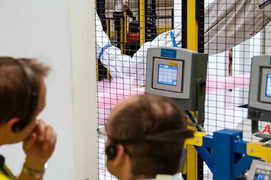 Lidé stedují zalakování kovové trubky robotickými rameny