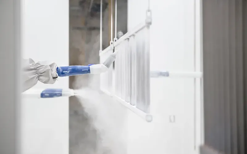 Radiator being automatically coated using powder coating