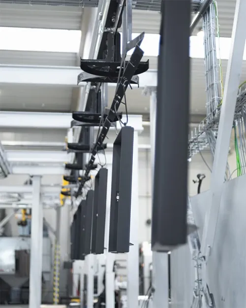 Hanged metal parts on an overhead conveyor