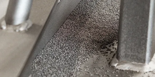 Abrasive on blasted part