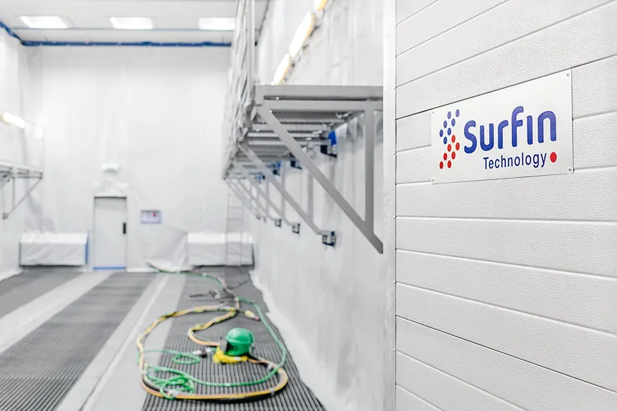 SURFIN Technology logo inside blasting chamber
