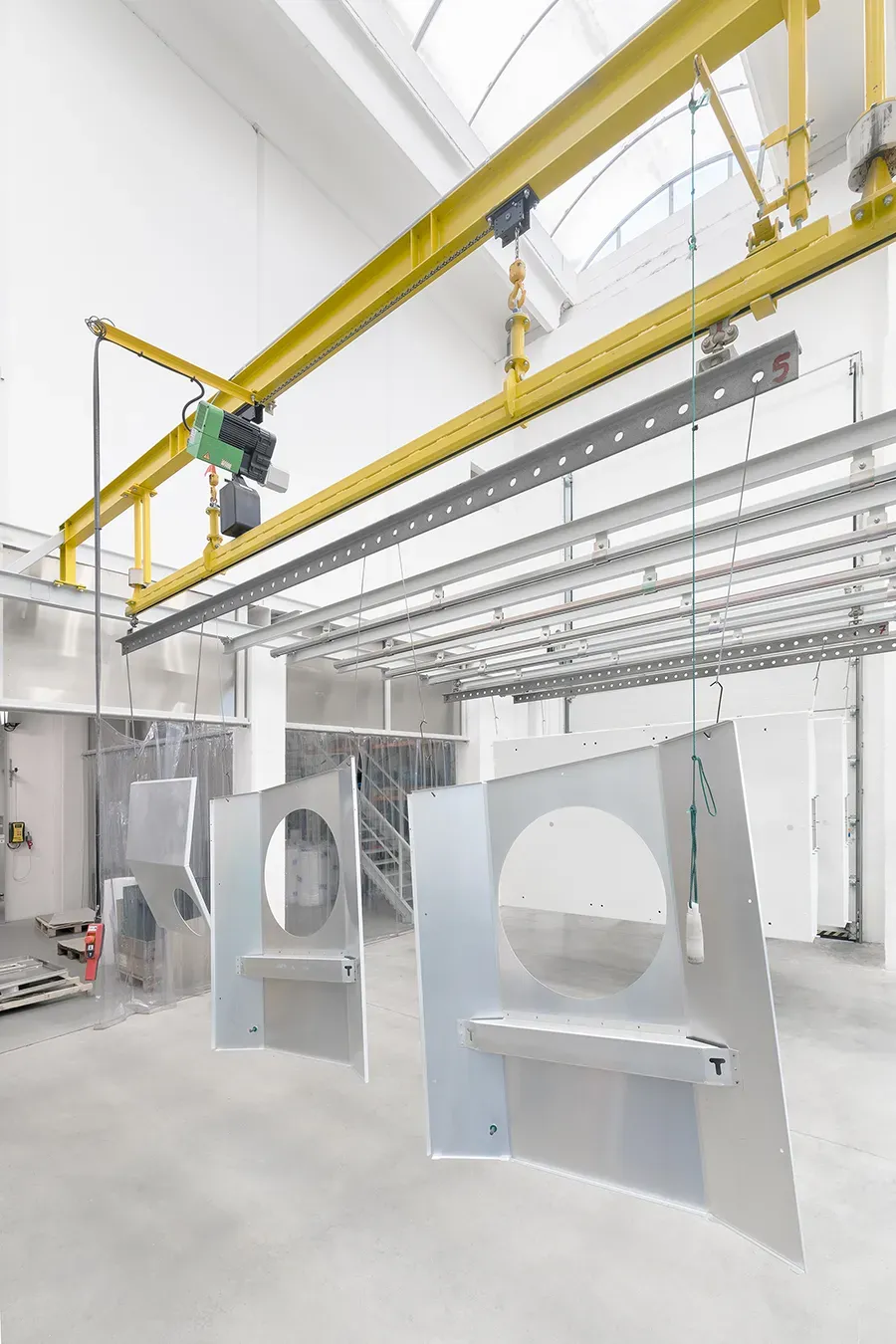 Metal parts hanging on a conveyor