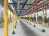 Overhead conveyor with manhole covers hanging
