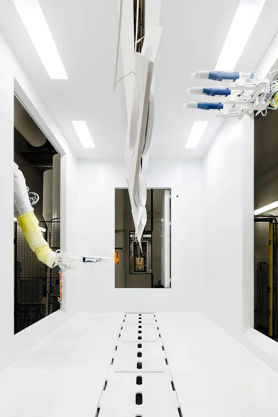 Metal part being coated by robots