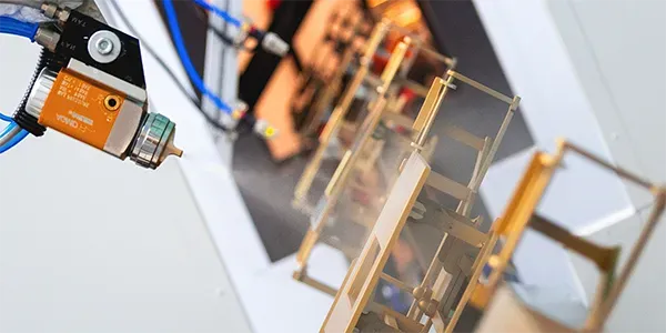 Robotic wet coating of plastic flushers