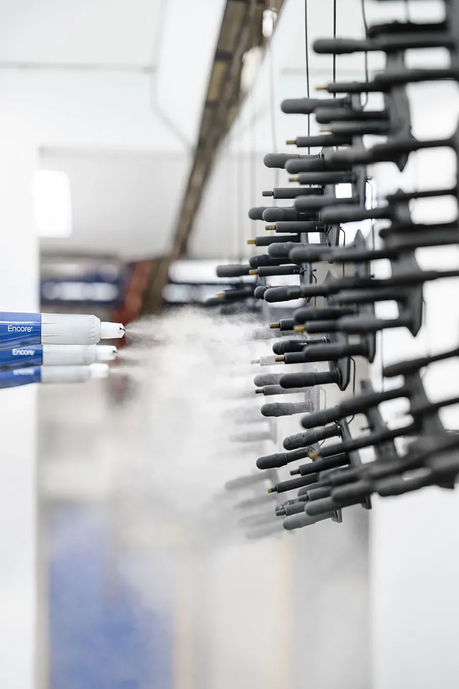 Metal parts being coated with powder coating